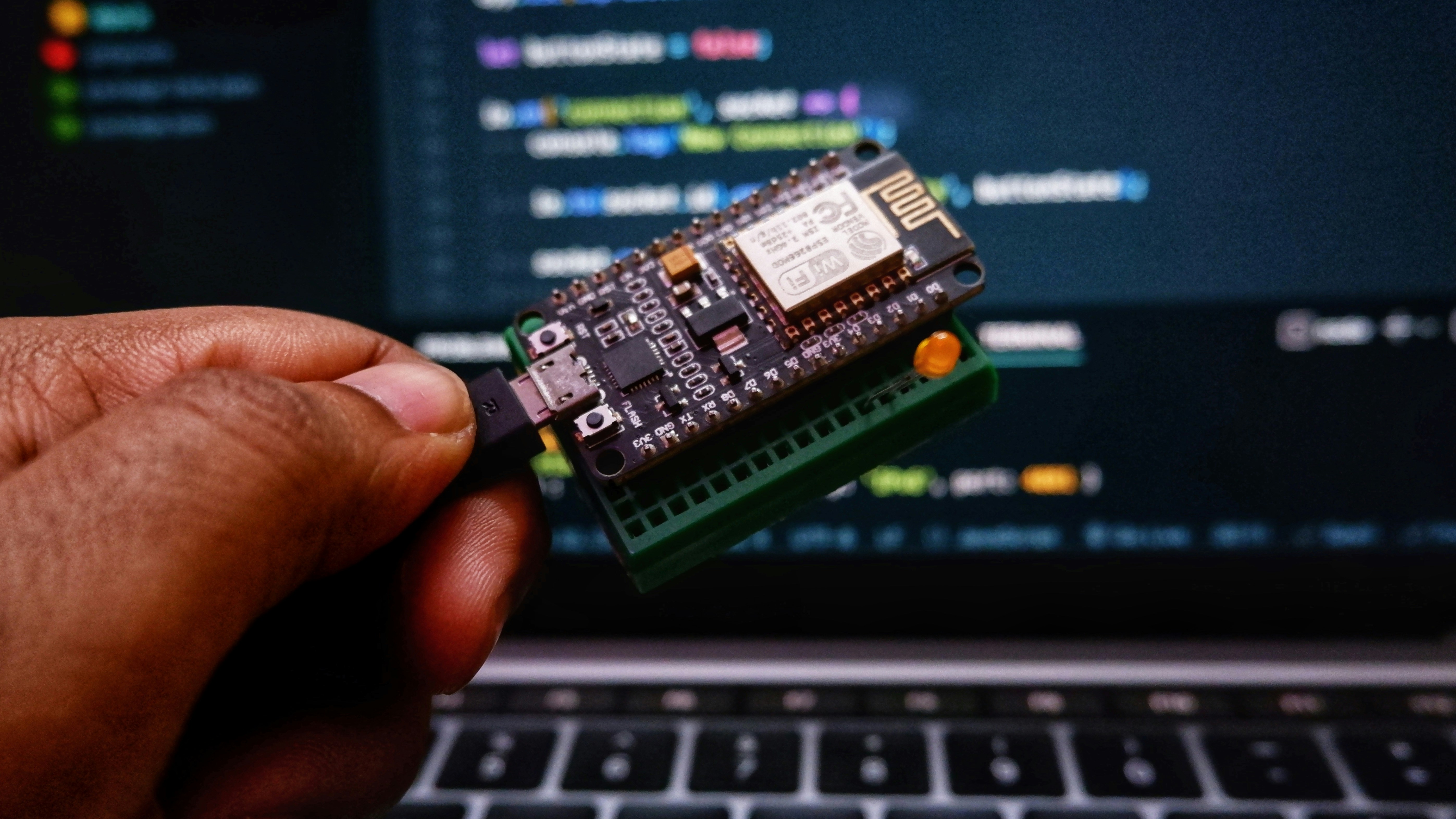Illustrative ESP32 development board beside firmware code